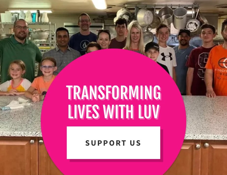 Volunteers and family serving together in a community kitchen